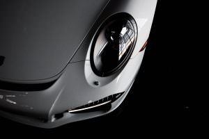 A closeup photo of a Porsche headlight