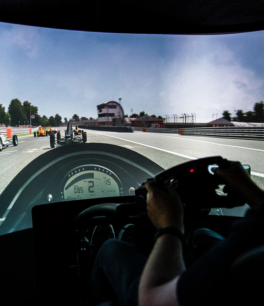 A first person view of a member driving a racing simulator