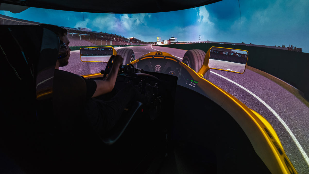 Photo of a member driving the racing simulator
