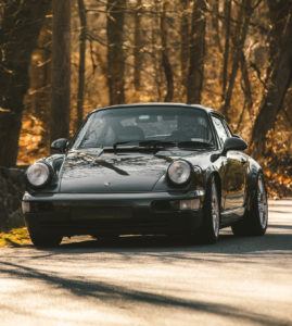 Grey Porsche 964 in the woods