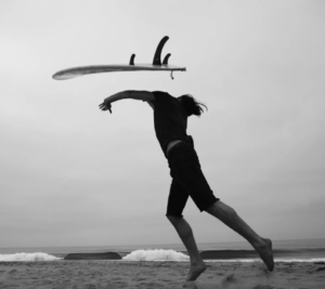 person throwing surfboard over head
