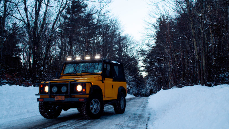 Defender driving on a snowy road